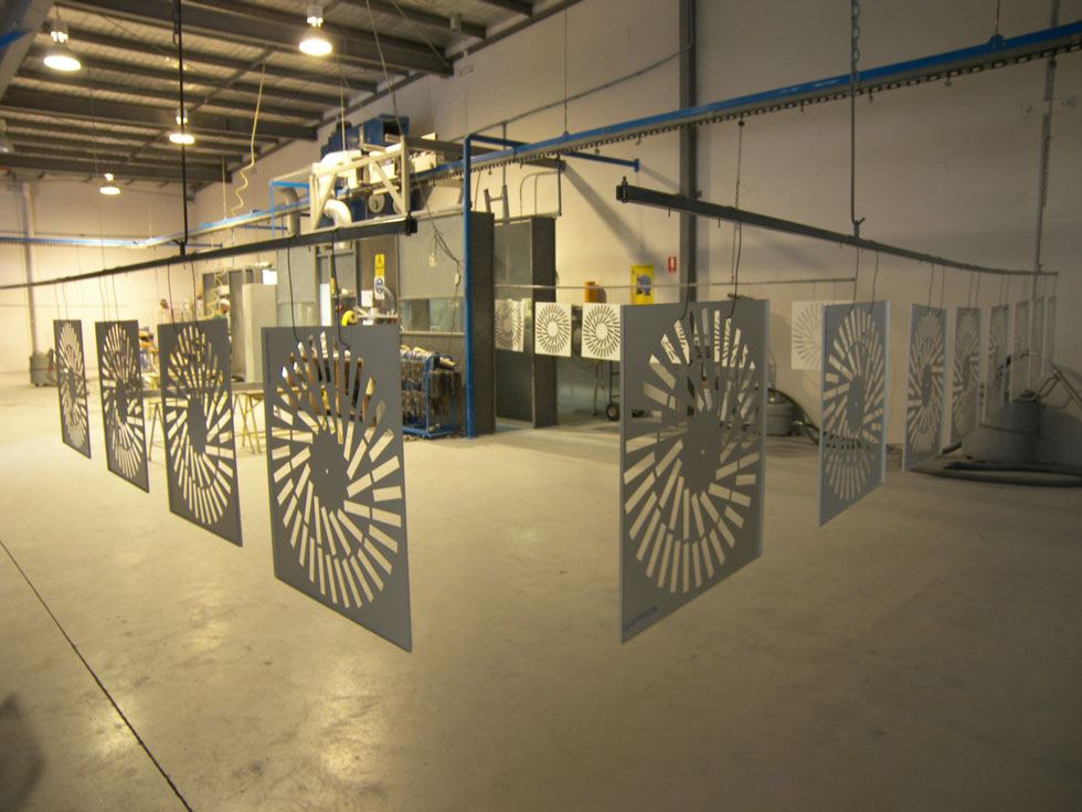 Laser cut panels on the powder coating conveyor